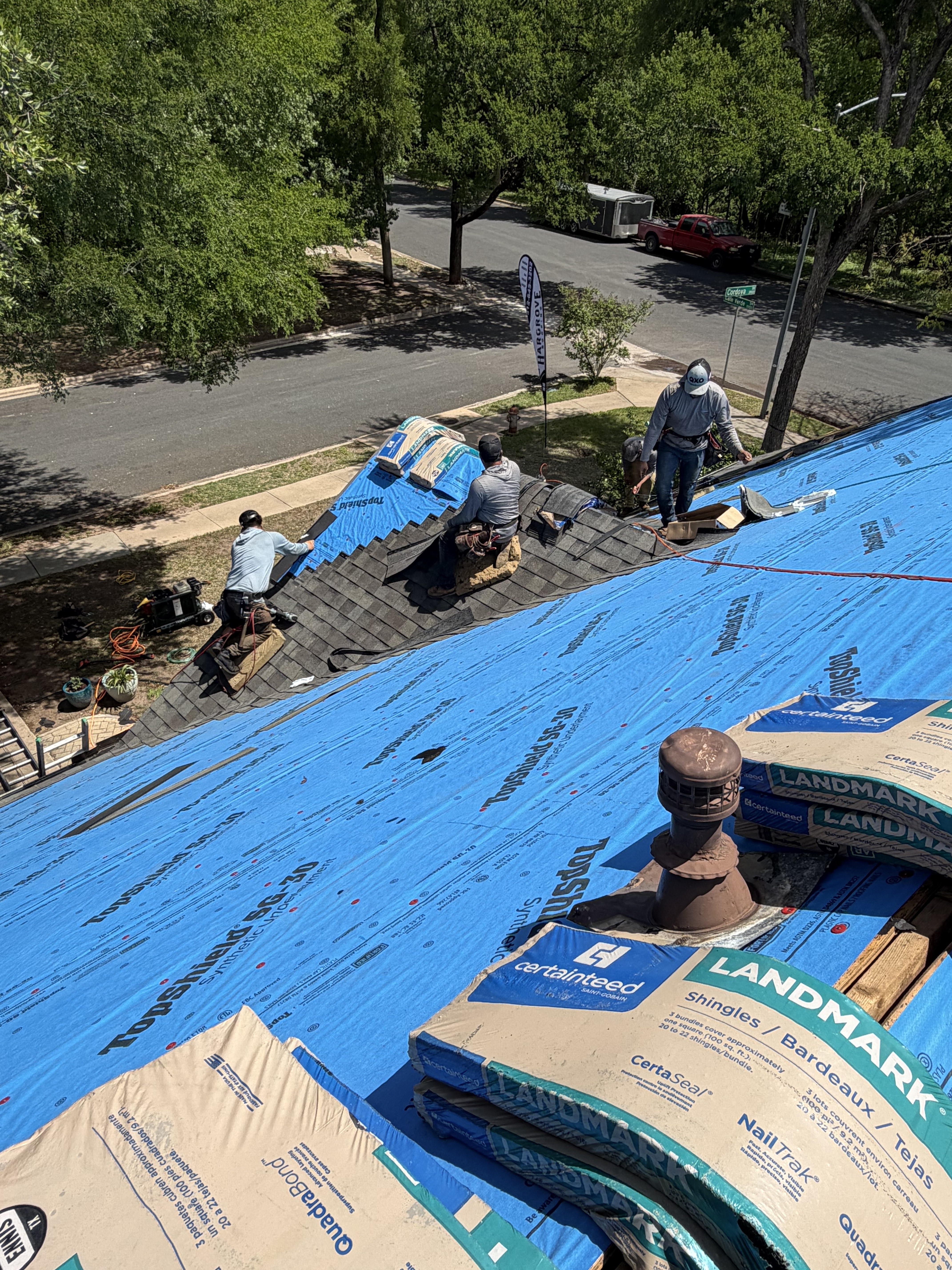 Serolf crew installing shingles